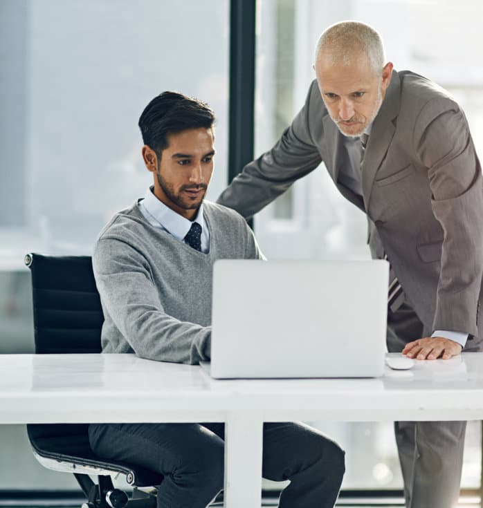 two men looking at the laptop
