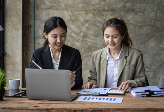 two woman working together